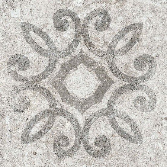 A bathroom setting showcasing a wall tiled with gray decorative porcelain tiles featuring a floral-like geometric pattern.