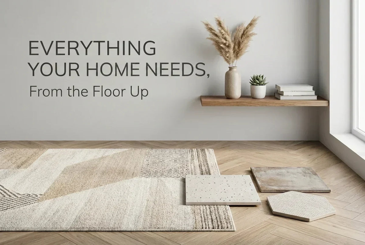 Blog header image featuring light wood herringbone flooring, a neutral geometric area rug, tile samples, and text reading "Everything Your Home Needs, From the Floor Up"
