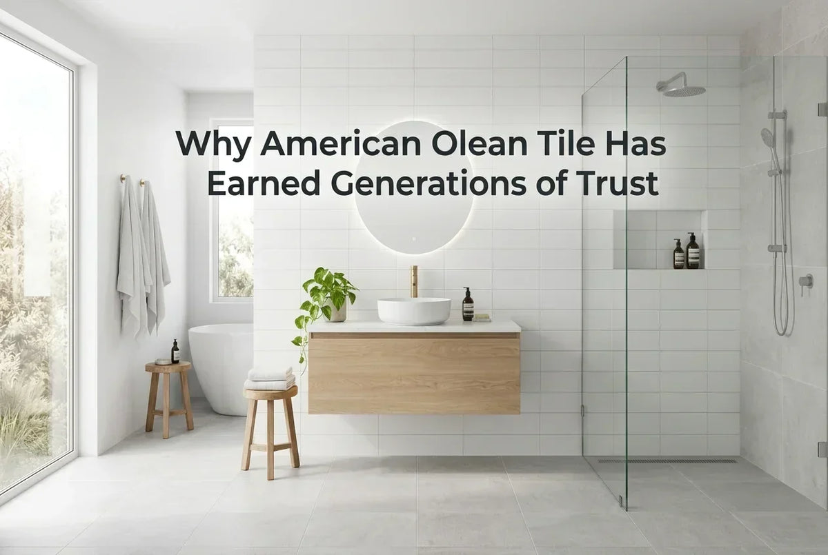 Modern bathroom with white wall tile, gray floor tile, a floating wood vanity, and a glass shower, illustrating the timeless style associated with American Olean tile.