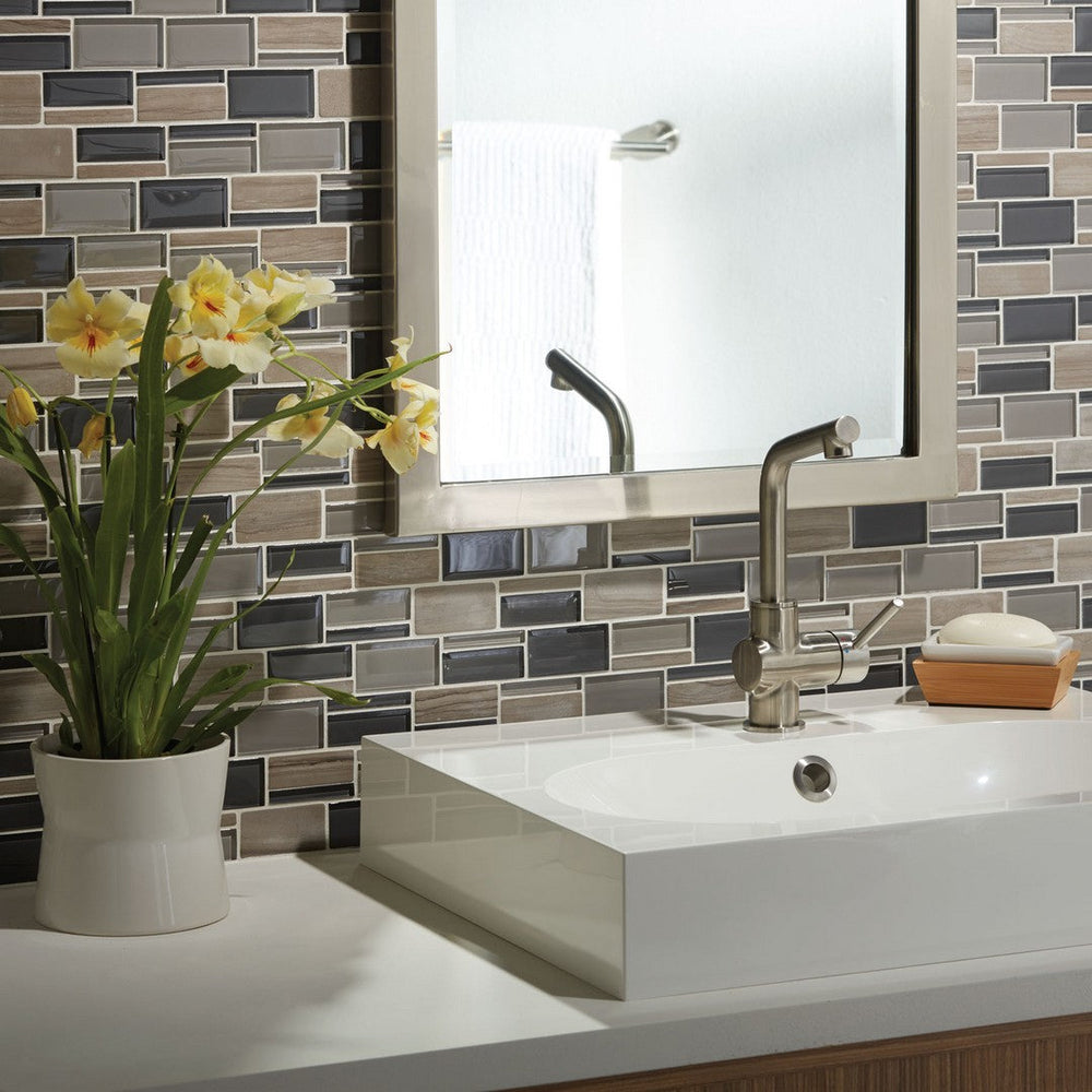 A high-end bathroom sink featuring a sleek American Olean Appeal Glass and Stone Mosaic installation across the floor.